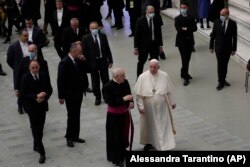 Pope Francis walks towards faithful at the end of his weekly general audience in the Paul VI Hall, at the Vatican, Wednesday, Dec. 22, 2021.