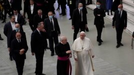 Pope Francis walks towards faithful at the end of his weekly general audience in the Paul VI Hall, at the Vatican, Wednesday, Dec. 22, 2021.