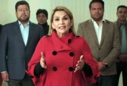FILE - This picture released by hte Bolivian goverment shows the interim president of Bolivia, Jeanine Anez, announcing her withdrawal from the presidential race a month before the elections in La Paz, Bolivia, Sept. 17, 2020.