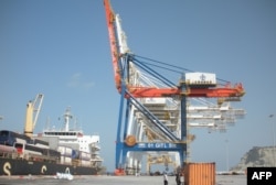 FILE - A Pakistani soldier stands guard near a container ship at Gwadar Port, Pakistan, Oct. 4, 2017. Development of the deep-sea port on the Arabian Sea was one of the first high-profile projects under the China-Pakistan Economic Corridor (CPEC) plan.