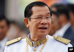 FILE - Cambodia's Prime Minister Hun Sen waits to attend Independence Day celebrations in Phnom Penh, Cambodia, Nov. 9, 2017. Hun Sen has been tightening his rule, in effect silencing all critical voices.