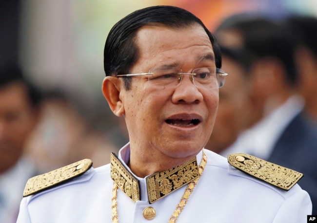 FILE - Cambodia's Prime Minister Hun Sen waits to attend Independence Day celebrations in Phnom Penh, Cambodia, Nov. 9, 2017. Hun Sen has been tightening his rule, in effect silencing all critical voices.