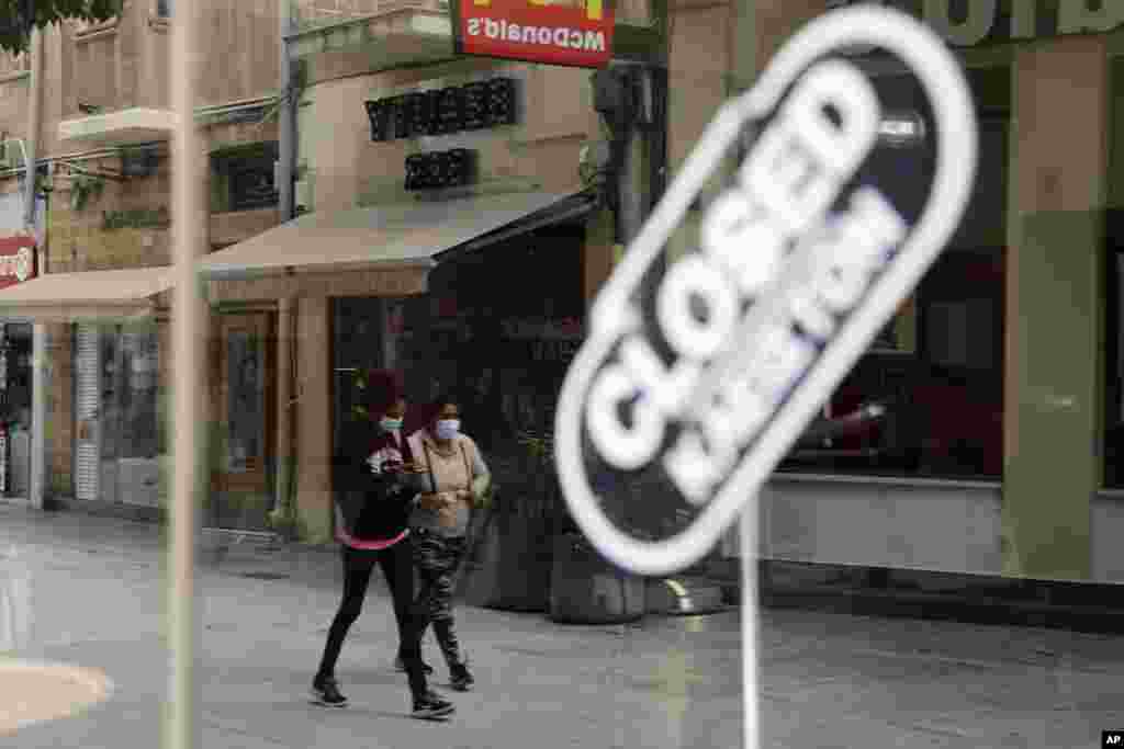 دو زن در حال عبور از خیابان‌های خلوت در مرکز خرید شهر نیکوزیا، قبرس
