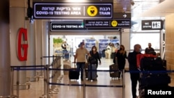 Travelers exit the coronavirus testing area at Ben Gurion International Airport as Israel imposes new restrictions near Tel Aviv, Israel, Nov. 28, 2021. 