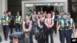 North Korean taekwondo demonstration team members and other officials arrive at Gimpo International Airport in Seoul, South Korea, June 23, 2017.