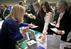 Patricia Mazza, left, meets job seekers, including recent college grads Ashley Deyo, 22, second from left, and Chyna Dama, 23, second from right, during a 2012 National Career Fairs' job search event in New York.