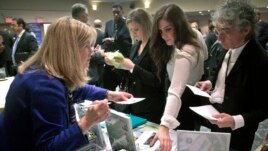 Patricia Mazza, left, meets job seekers, including recent college grads Ashley Deyo, 22, second from left, and Chyna Dama, 23, second from right, during a 2012 National Career Fairs' job search event in New York.