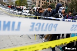 Students walk past police line tape on their way to school a day after a man driving a rented pickup truck mowed down pedestrians and cyclists on a bike path alongside the Hudson River in New York City, Nov. 1, 2017.