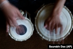 FILE - In this May 11, 2010 file photo, a student learns to play the tabla at the Afghan National Institute of Music, ANIM, in Kabul, Afghanistan.