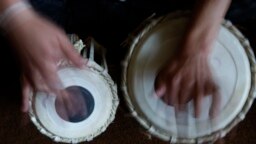 Seorang siswa belajar memainkan tabla di Institut Musik Nasional Afghanistan sebagai ilustrasi. Empat musisi Afganistan, yang kini bermain dan belajar di National Conservatory, tampil bersama beberapa rekan Portugis mereka. (Foto: AP)