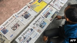 FILE - A vendor arranges newspapers in Siliguri, India, Jan. 21, 2021.