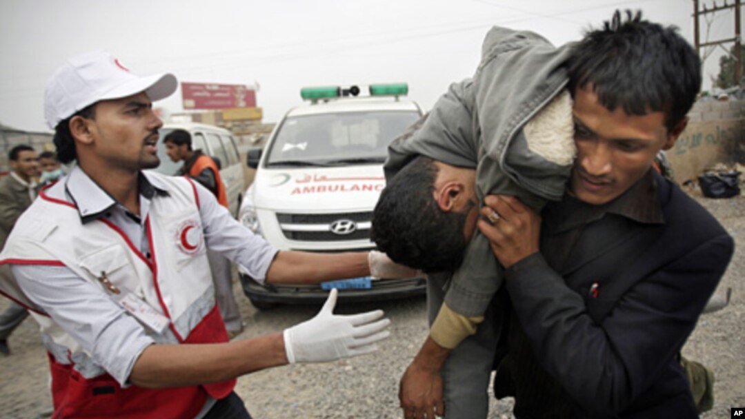 A man carries a wounded protester during clashes in Sana'a, Yemen, Nov. 24, 2011.