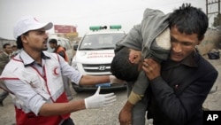 A man carries a wounded protester during clashes in Sana'a, Yemen, Nov. 24, 2011.