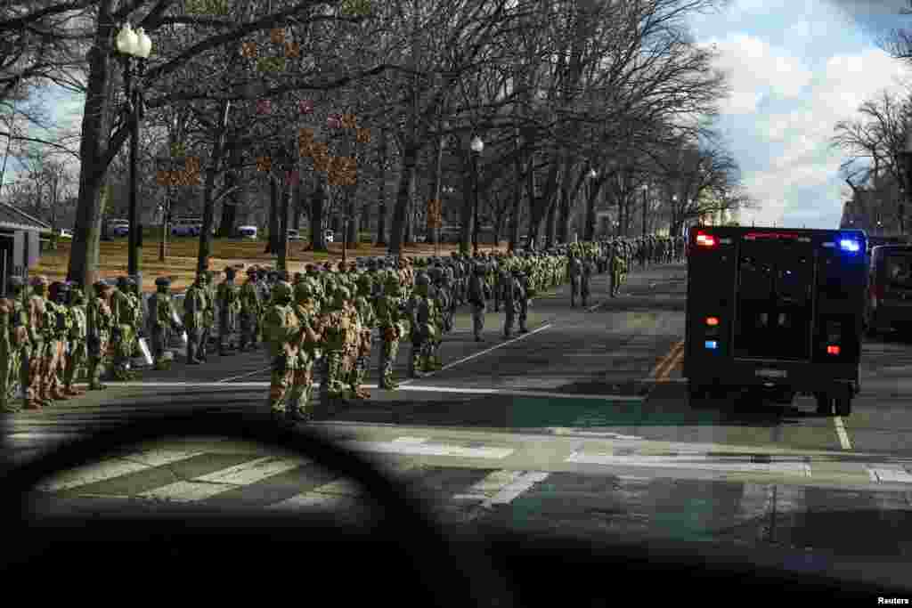 Military personnel standby along Pennsylvania Avenue as U.S. President-elect Joe Biden&#39;s motorcade arrives at the U.S. Capitol, in Washington.