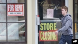 A man walks past a closed business, April 29, 2020