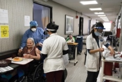 FILE - Nursing home residents receive a coronavirus vaccine at King David Center for Nursing and Rehabilitation, a nursing home facility, in Brooklyn's Bath Beach neighborhood in New York City, Jan. 6, 2021.