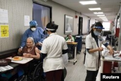 FILE - Nursing home residents receive a coronavirus vaccine at King David Center for Nursing and Rehabilitation, a nursing home facility, in Brooklyn's Bath Beach neighborhood in New York City, Jan. 6, 2021.