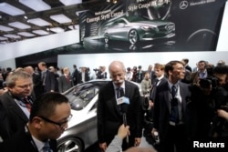 Daimler AG Chief Executive Officer Dieter Zetsche (C) speaks to the media after he unveiled the Mercedes-Benz Concept Style Coupe at Auto China 2012 in Beijing, April 23, 2012.