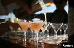 FILE - A bartender pours martinis on a yacht at the United States Sailboat Show in Annapolis, Maryland.