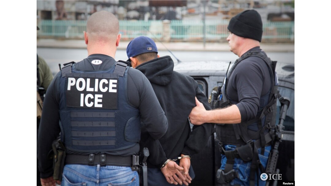 FILE - U.S. Immigration and Customs Enforcement officers detain a suspect as they conduct a targeted enforcement operation in Los Angeles, Feb. 7, 2017.
