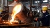 Workers pour molten steel at a factory producing auto parts for domestic and export in Binzhou, Shandong, China, Dec. 10, 2024.