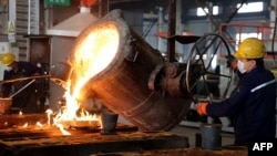 Workers pour molten steel at a factory producing auto parts for domestic and export in Binzhou, Shandong, China, Dec. 10, 2024.