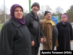 Abdul Hameed Omar, with cane, at a bus stop in Giessen, Germany, with his friends.