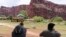 A helicopter lands to rescue people from flooding on the Havasupai reservation in Supai, Ariz., July 12, 2018. Rescue workers were evacuating about 200 tourists Thursday who were caught in flash flooding at a popular campground on tribal land near the Grand Canyon where visitors go to see towering blue-green waterfalls.