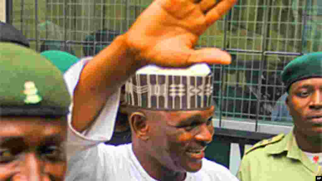 Hamza Al-Mustapha, the former chief security officer to Nigeria&#39;s late military ruler Sani Abacha, is escorted by prison officials as he leaves the Lagos high court at Igbosere district.