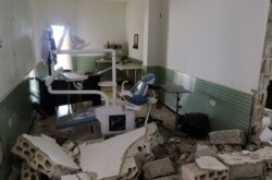 FILE - Damage is seen at a hospital after an airstrike in Deir al-Sharqi village in Idlib province, Syria, April 27, 2017.