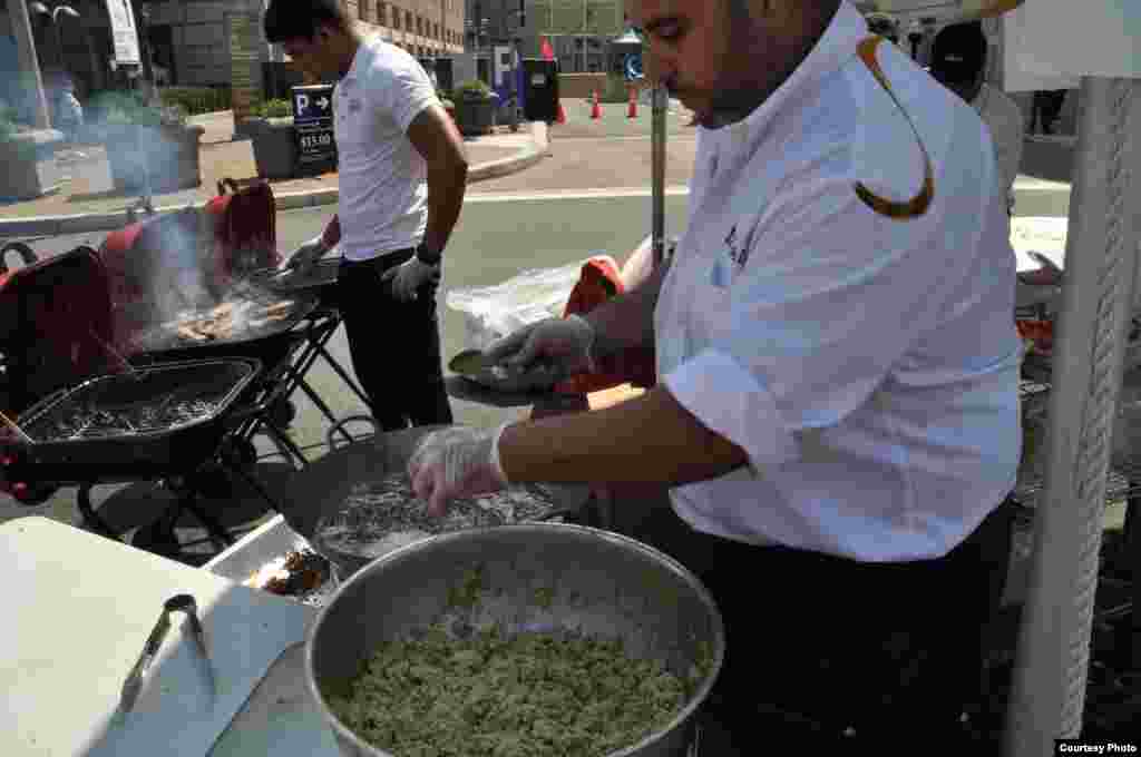 Cooks from the Middle Eastern restaurant Bawadi Mediterranean Grill and Cafe prepare falafel sandwiches for hungry festivalgoers in Washington, Sept. 3, 2017. (Photo courtesy of Rabah Seba)