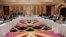 FILE - This Qatar Ministry of Foreign Affairs photo from Feb. 25, 2019, shows U.S. and Taliban representatives meeting in Doha to discuss ways to end the Afghan war. 