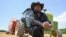 Farmer John Boyd Jr., poses for a portrait during a break from bailing hay at his farm in Boydton, Va., May 27, 2021. 