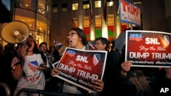 Protesters opposed to the appearance of Republican presidential candidate Donald Trump's appearance as a guest host on this weekend's "Saturday Night Live," shout anti-Trump slogans in front of NBC Studios in New York, Nov. 4, 2015 