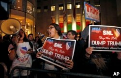 FILE - Protesters opposed to the appearance of Republican presidential candidate Donald Trump's appearance as a guest host on this weekend's "Saturday Night Live," shout anti-Trump slogans in front of NBC Studios in New York, Nov. 4, 2015.