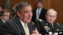 Defense Secretary Leon Panetta, left, accompanied by Joint Chiefs Chairman Gen. Martin Dempsey testifies on Capitol Hill in Washington, June 13, 2012.