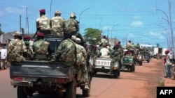Central African troops in charge of disarmament drive a tank through Bangui, Central African Republic, Sept. 5, 2013.