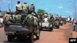 FILE - Central African troops in charge of disarmament drive a tank through Bangui, Central African Republic.