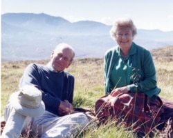 Handout image released by Buckingham Palace of a personal photograph of the Britain's Queen Elizabeth II and Prince Philip, at the top of the Coyles of Muick, taken by the Countess of Wessex in 2003 and obtained by Reuters April 16, 2021.