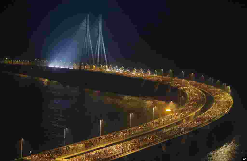 Runners compete along the Bandra-Worli sea link over the Arabian Sea during the Mumbai Marathon in Mumbai, India.