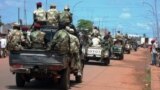 FILE - Central African troops in charge of disarmament drive a tank through Bangui, Central African Republic.