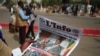 A journalist reads a local newspaper bearing the late Chadian president Idriss Deby on the front page, during the state funeral for Deby in N'Djamena, Chad, April 23, 2021. 