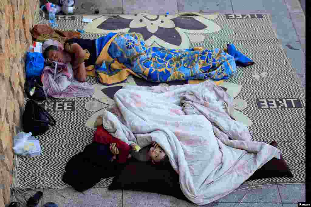 Displaced people sleep along the seaside in western Beirut, Lebanon, amid the ongoing hostilities between Hezbollah and Israeli forces.