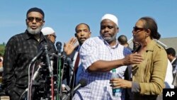 Ibrahim Rahim (2-R), brother of shooting victim Usaama Rahim, reacts with a relative during a news conference June 4, 2015, in Boston's Roslindale neighborhood, in the area where Rahim was shot to death.
