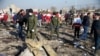 Security officers and Red Crescent workers are seen at the site where the Ukraine International Airlines plane crashed after takeoff from Iran's Imam Khomeini airport, on the outskirts of Tehran, Jan. 8, 2020.