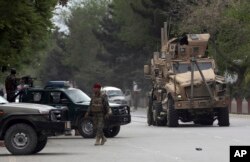 A damaged US military vehicle is being pulled near the site of a suicide attack in Kabul, Afghanistan, May 3 , 2017. Afghan officials say that at least four people have been killed in a suicide car bomb attack in the capital Kabul.