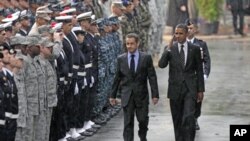 U.S. President Barack Obama (R) salutes as he walks with France's President Nicolas Sarkozy during a Franco-American alliance ceremony at the end of the G20 Summit for Heads of State and Government in Cannes, France, November 4, 2011.