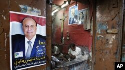 A Sana’a maker of traditional daggers displays loyalties to President Hadi (left) and to Saleh, Yemen’s ousted ex-president (AP)