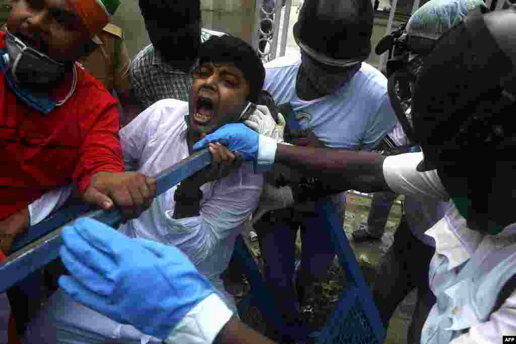 Activists of Congress Party shout slogans against the Bharatiya Janata Party (BJP) led central government and state Governors as they try to break police barricades in front of the Raj Bhavan (Governor&#39;s House) in Kolkata, India.