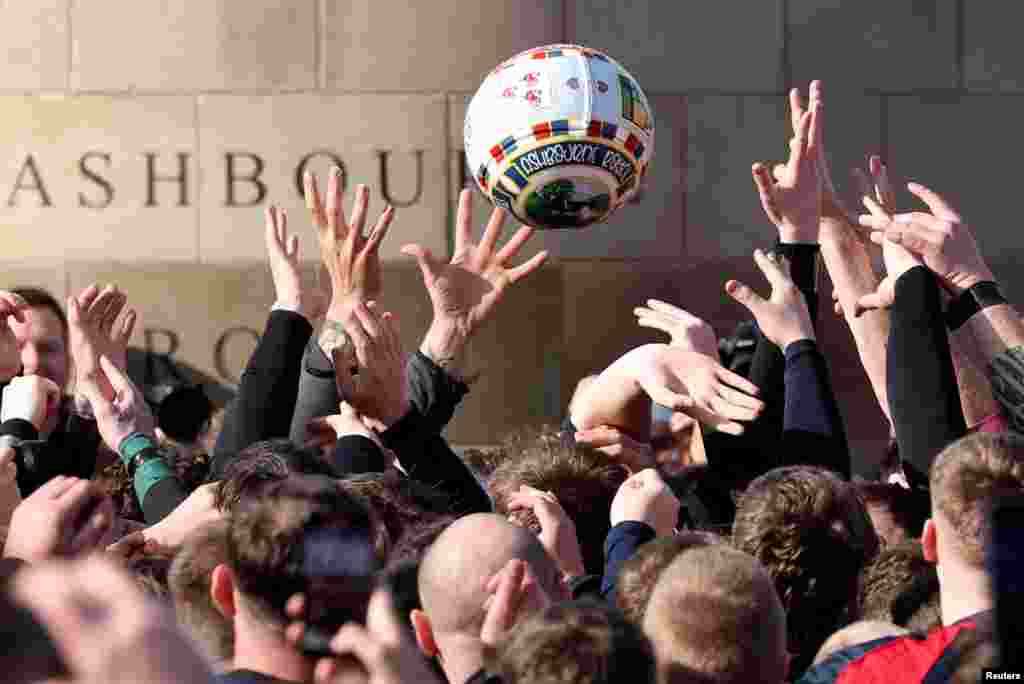 Players from the Up&#39;ards and Down&#39;ards teams compete for the ball during the annual Royal Shrovetide football match in Ashbourne, Britain.